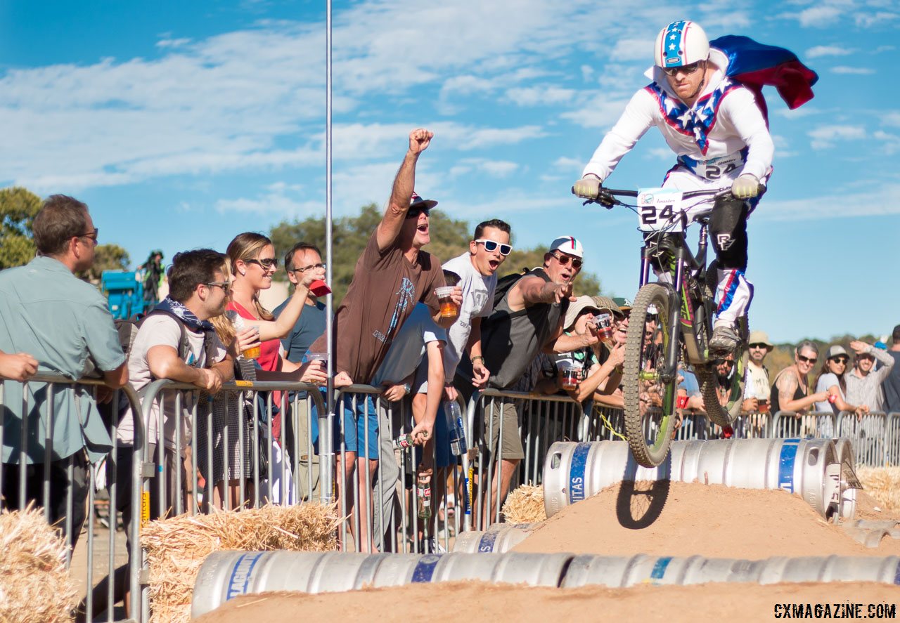 Evil Knielvel gets big air, entertains fans over the beer kegs. 2015 ClifBar Cykel Scramble. © A. Yee / Cyclocross Magazine