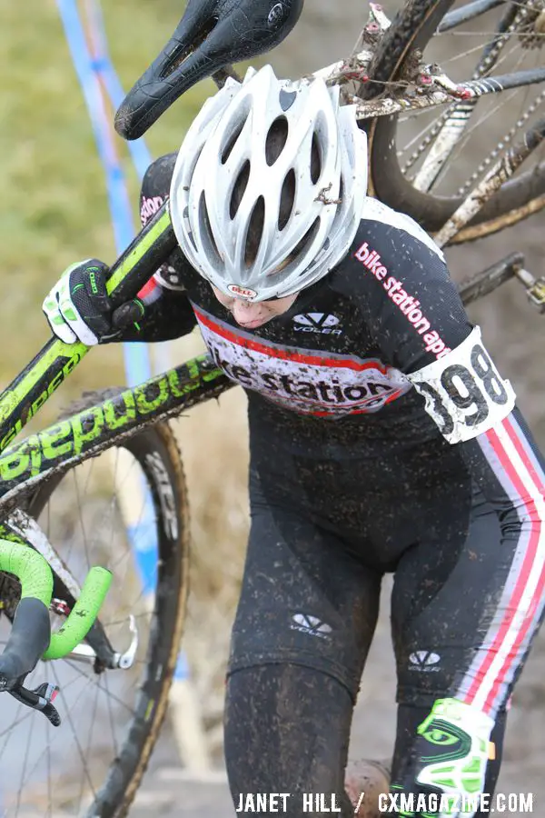 Devon Haskell Shoulders her Bike. © Janet Hill