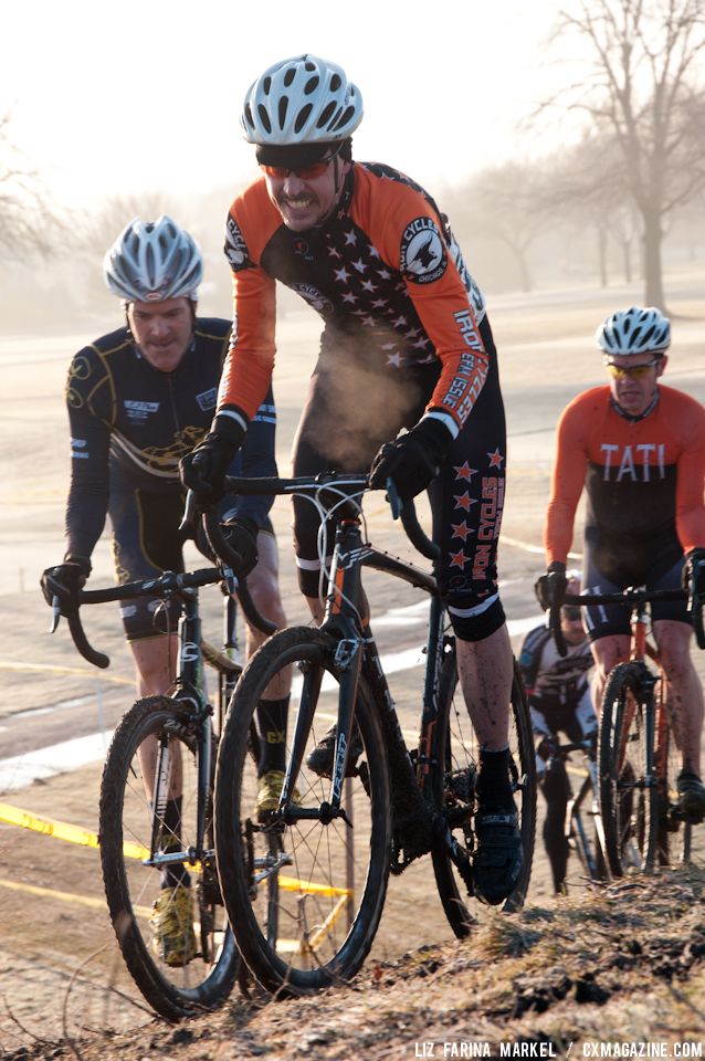 Dominic Casey (Iron Cycles) and Mike Norman (Pony Shop) charge up the hill in the Masters 40-plus race during the cold, early morning hours on Saturday. ©Liz Farina Markel