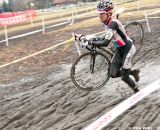 Christopher Jones (Rapha-FOCUS) finds running is the fastest way to get through the mud. ©Liz Farina Markel