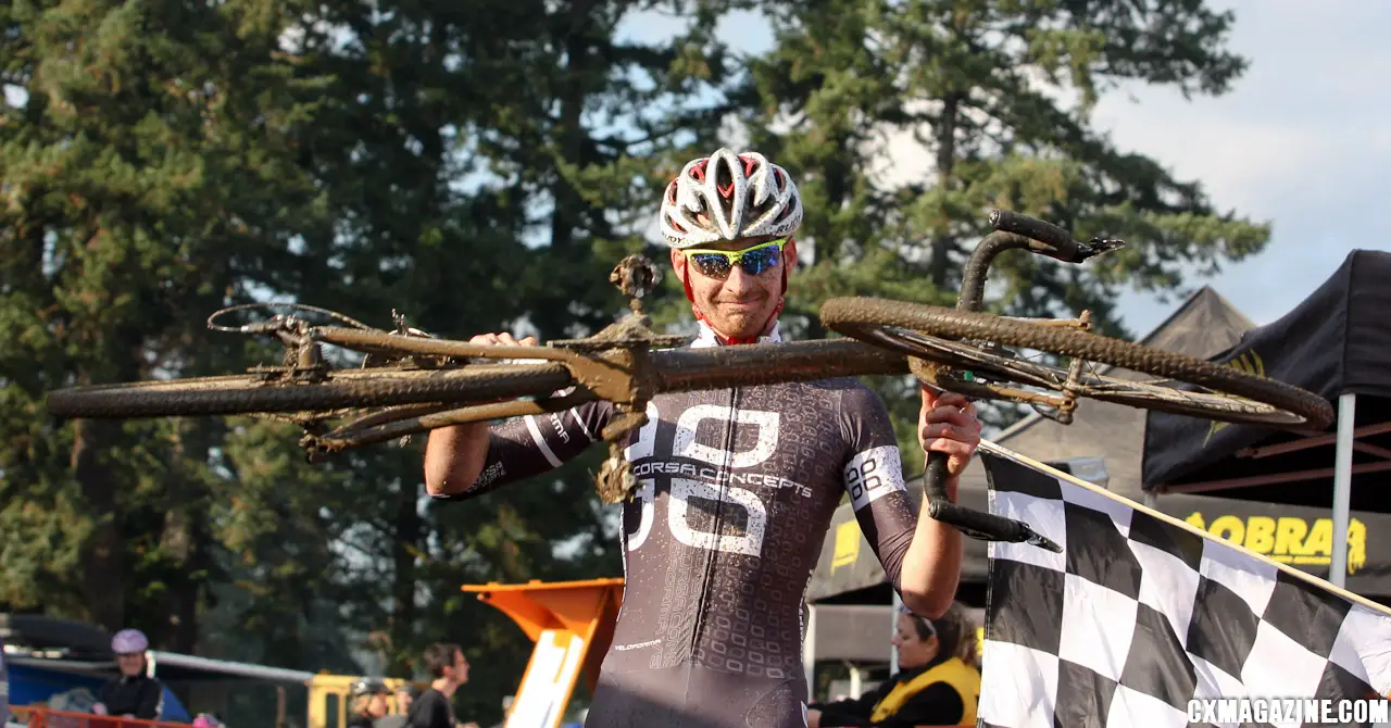 Aaron Tuckerman hoists his bike at the finish line after wining Cross Crusade #7. ©Pat Malach