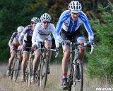 The men's lead chasing group motors over the berm that divided the course. ©Pat Malach