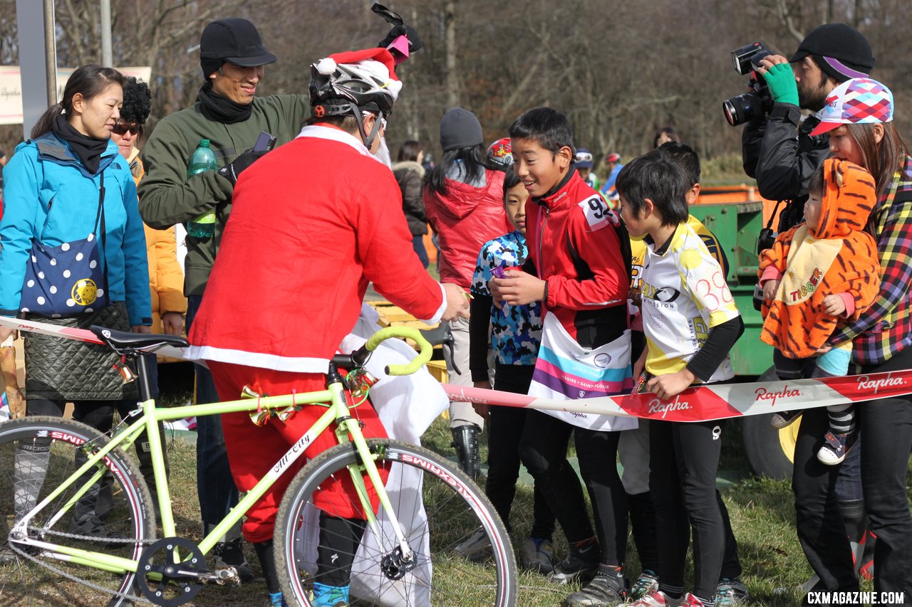 A Santa stopped along the course in the singlepseed race to give out candy to the kids. 2011 Nobeyama, Japan UCI Cyclocross Race. © Cyclocross Magazine