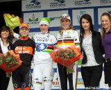 The podium of the women's race. The riders flanked by the podium girls.