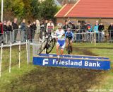 Vos jumping the barriers with Wyman behind © Thomas van Bracht