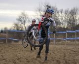 Nicole Thiemann leads a rider through the sandpit. © Cyclocross Magazine