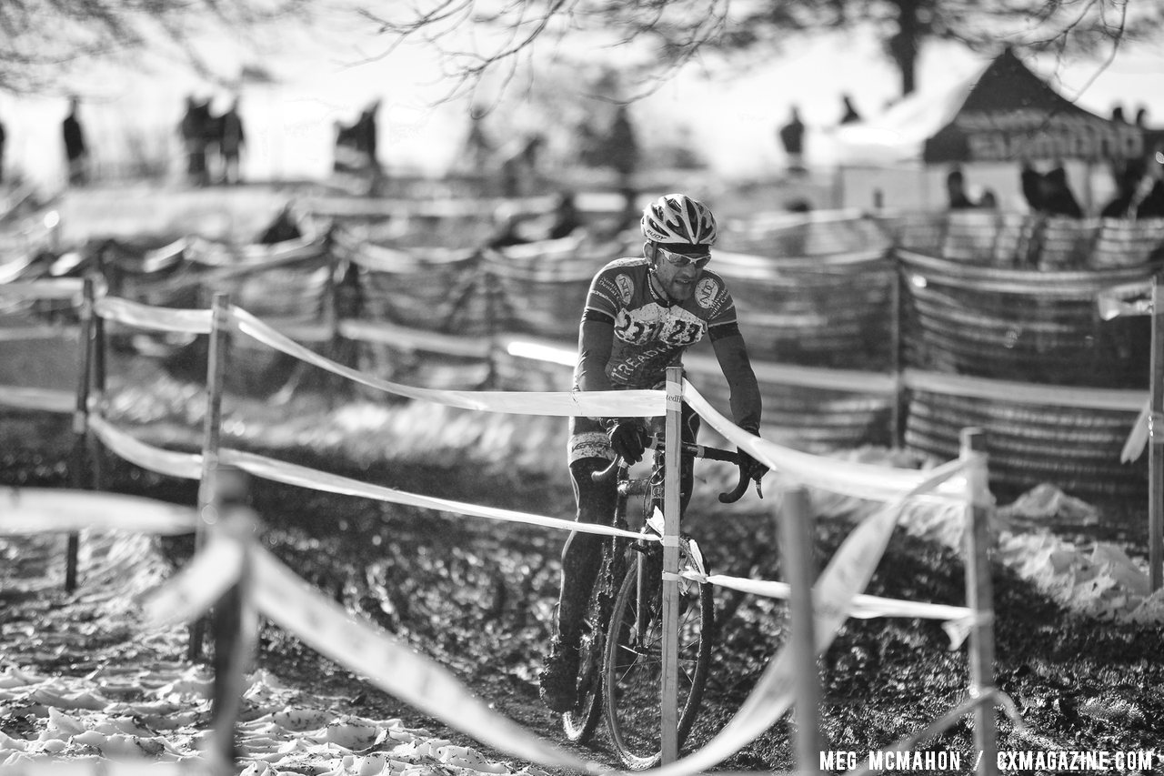 Gabriel Ion finds reason to smile heading towards the pits. Masters Men 40-44, 2013 Cyclocross Nationals. © Meg McMahon