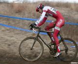 Brady Kapius rides with course tape caught in his crankset. © Cyclocross Magazine