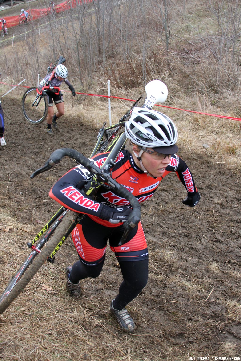 Sam Schneider picking her way through the slippery mud. © Amy Dykema