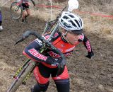 Sam Schneider picking her way through the slippery mud. © Amy Dykema