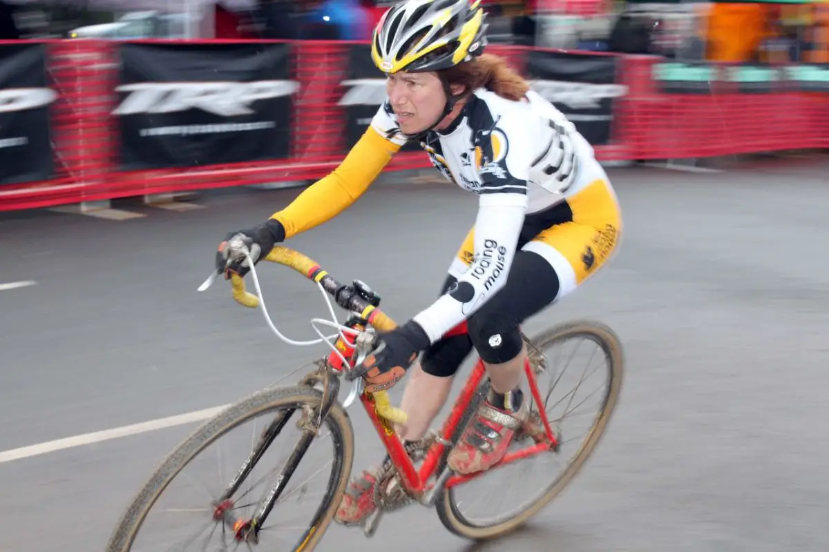 Roaring Mouse\'s Julie Bates flies through the course\'s first corner in the Masters Women\'s race. © Cyclocross Magazine