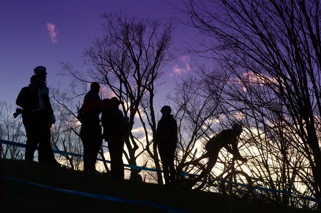 Spectators watch from atop a ridge as Durrin rides to his first UCI win. © Todd Prekaski