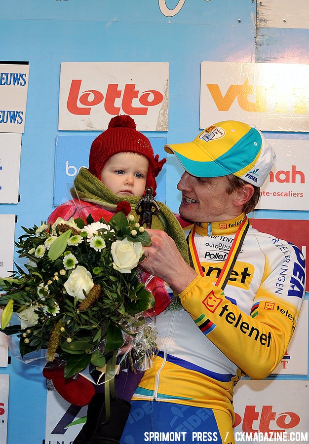 Bart Wellens holding his child on the podium as he finished 2nd the 2011 Belgian Championship cyclo cross race in Antwerpen. Sunday Jan. 9, 2010. ( SPRIMONT PRESS / Laurent Dubrule )