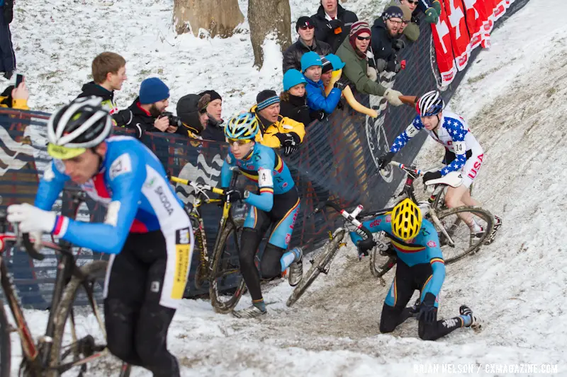 The Belgian rider goes down and Logan Owen chases at the Elite World Championships of Cyclocross 2013. © Brian Nelson