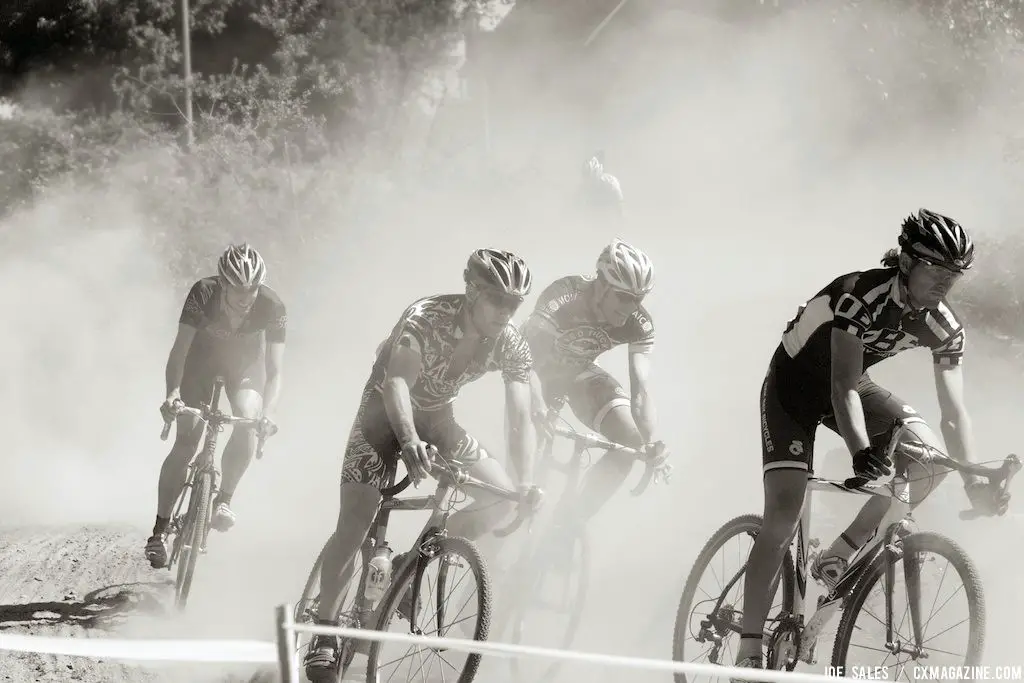 In a dust cloud, the riders came together in a pack. © Joe Sales