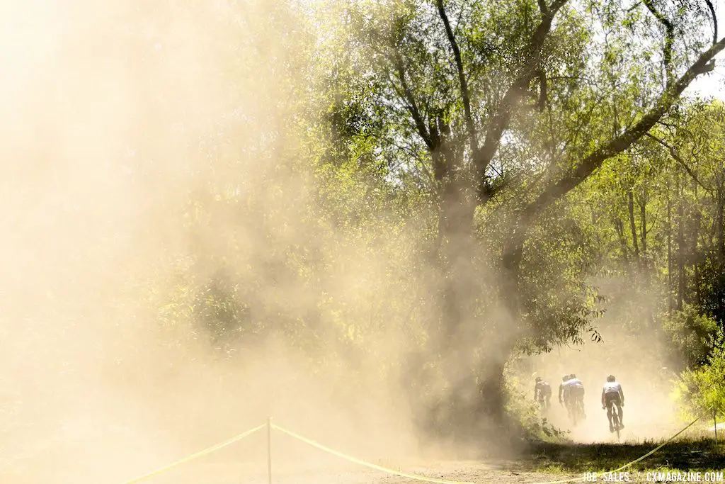 Through the dust, riders appear. © Joe Sales