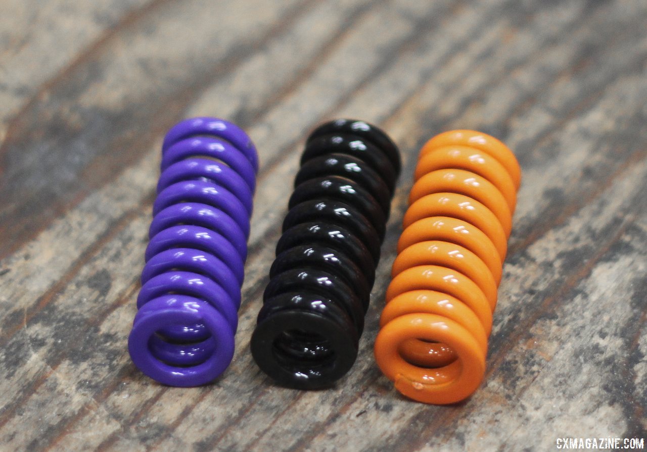 Calfee has five different springs of varying stiffness, shown are the medium (purple), medium/stiff (black) and stiffest springs (orange). © Cyclocross Magazine