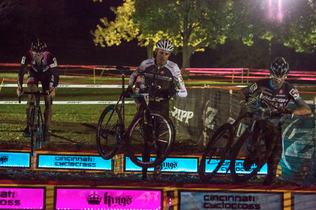Men hit the barriers at Kings CX After Dark. 