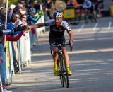 Tim Johnson high-five’s fans on the way to the win. © Kent Baumgardt