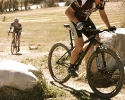 Bo Pihl hammers up a climb on his singlespeed as Courtney Gregory is fast approaching. by Karen Jarchow