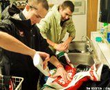 Zane Godby and Yannick Eckmann clean their kits the old fashion way after a day in the mud. © Tom Robertson