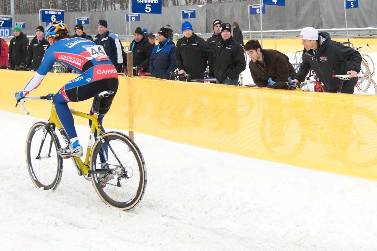 Danny Summerhill riding by the pit with Geoff Proctor offering encouragement