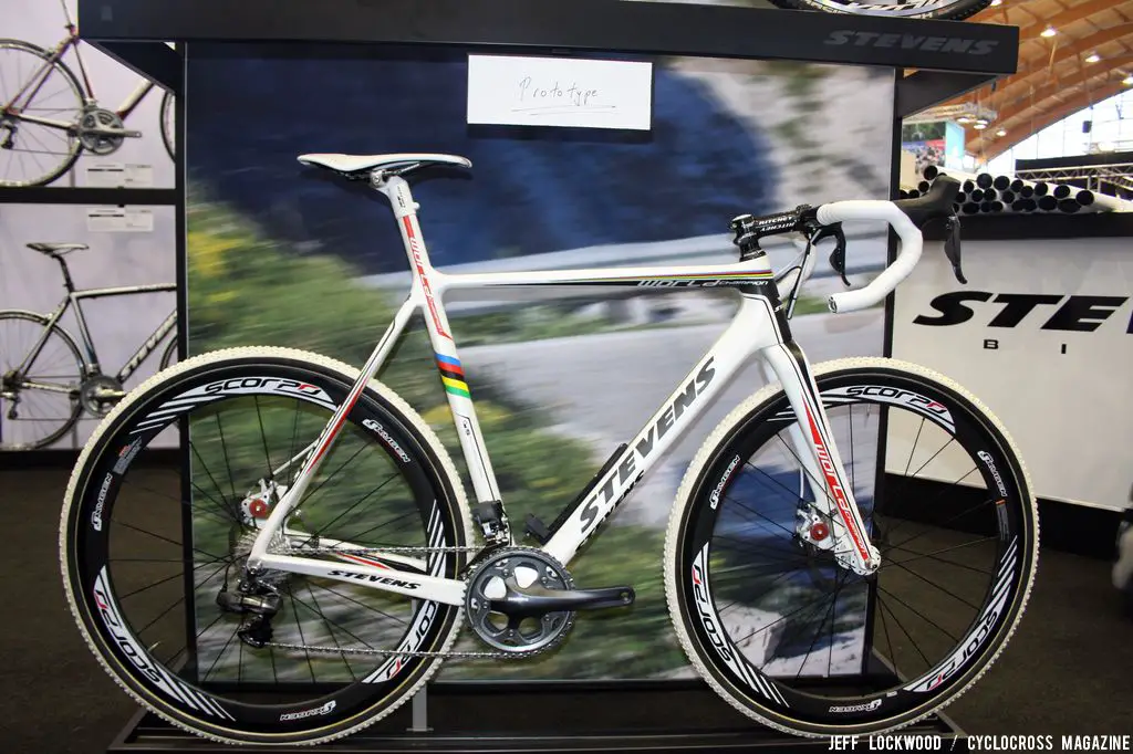 Stevens is displaying a an interesting prototype: white carbon fiber beauty features disc brakes and integrated seat mast & internal cable routing. Though there is no battery present, the bike definitely features Di2 Dura Ace shifters. © Jeff Lockwood