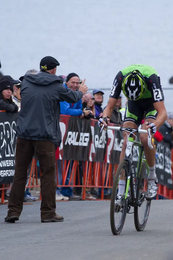 Announcer and Providence Cyclocross Festival Organizer Richard Fries gives Trebon one lap to go © Todd Prekaski