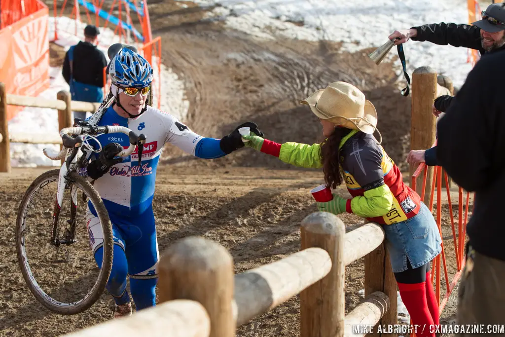 Taking handups in the men\'s 50-54 race at 2014 USA Cyclocross National Championships. © Mike Albright