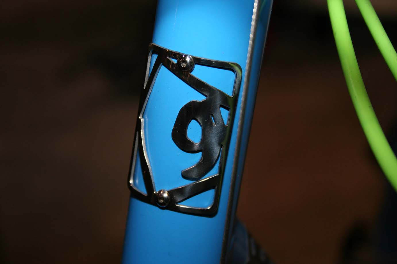 An intricate, metal head badge indicates this isn't a mass-produced frame.  ?Cyclocross Magazine