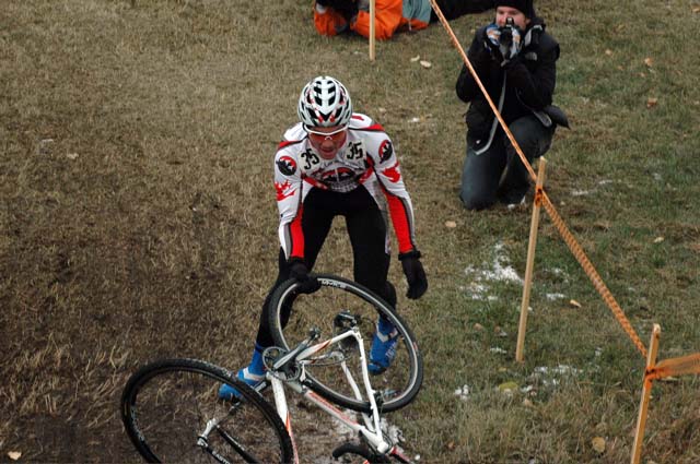  Evan Guthrie (Rocky Mountain) retrieving his bike after coming off it on one of the slippery downhills.