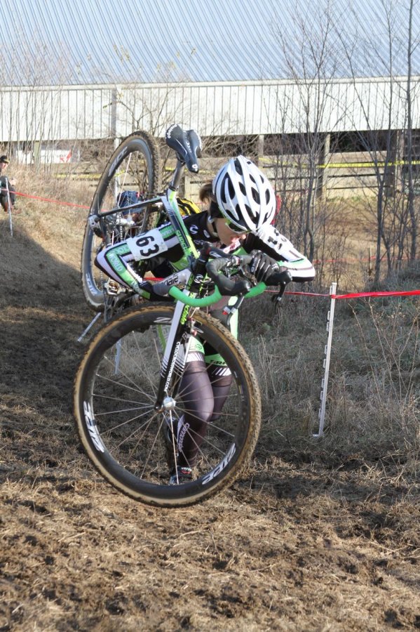 Kaitie Antonneau shouldering the bike up the hill. © Amy Dykema