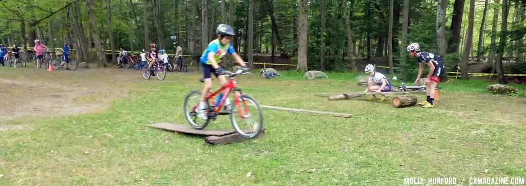 Practicing riding in a straight line, over a board and log setup © Cyclocross Magazine