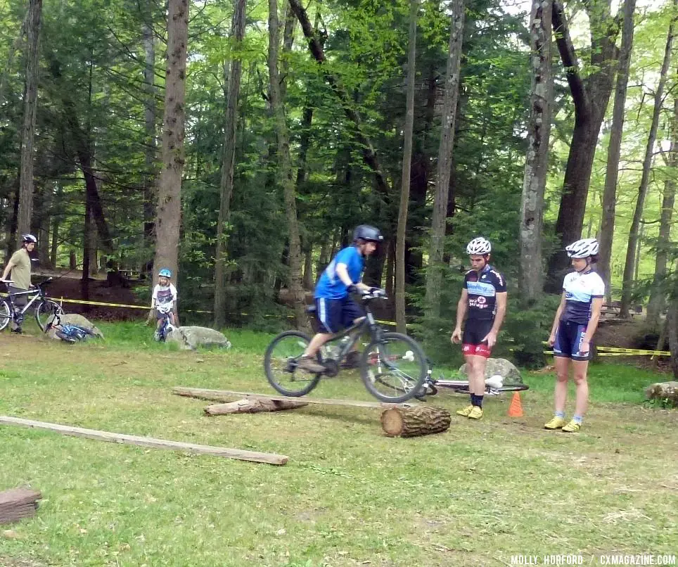 Practicing riding in a straight line, over a board and log setup © Cyclocross Magazine