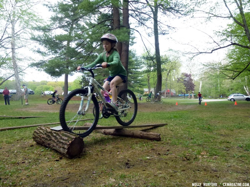 Practicing riding in a straight line, over a board and log setup © Cyclocross Magazine