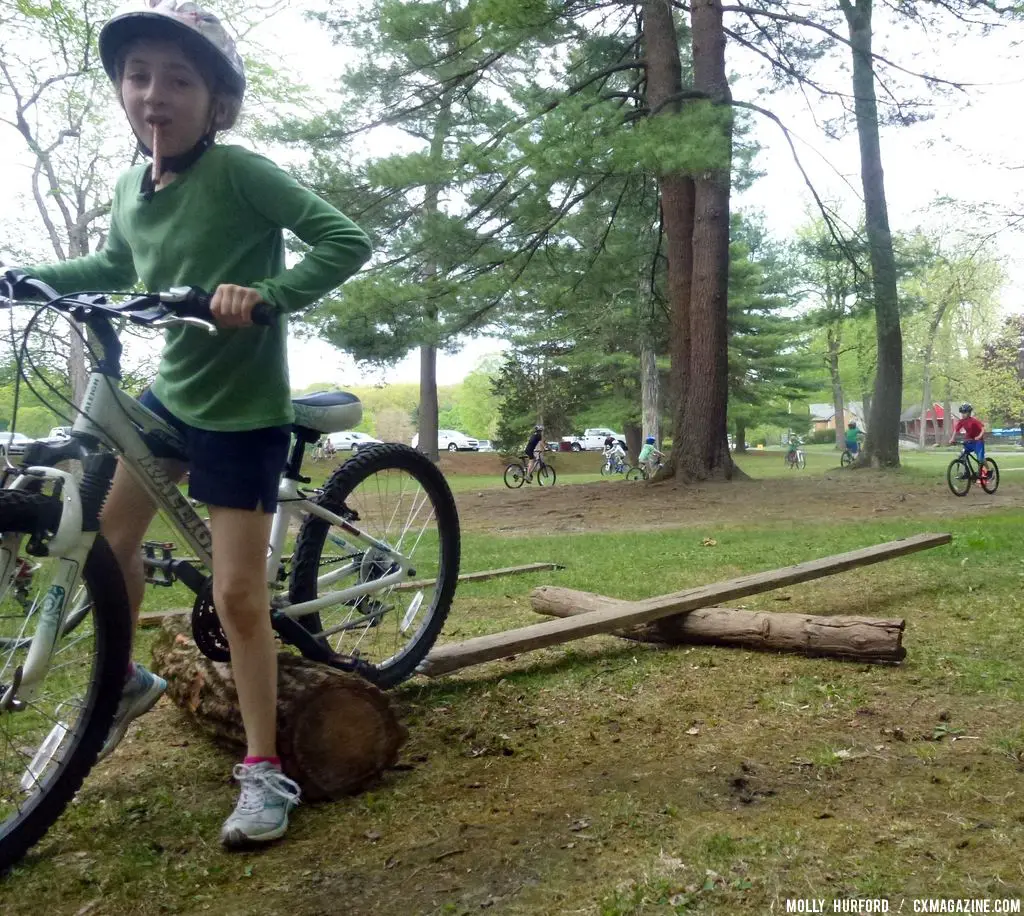 Practicing riding in a straight line, over a board and log setup © Cyclocross Magazine