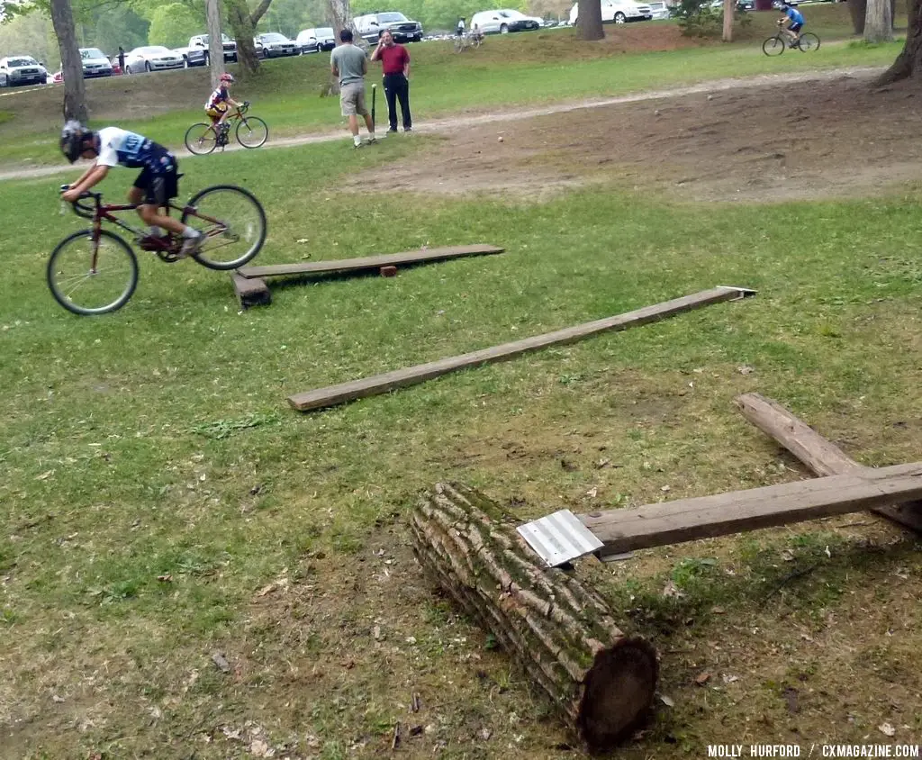 Practicing riding in a straight line, over a board and log setup © Cyclocross Magazine