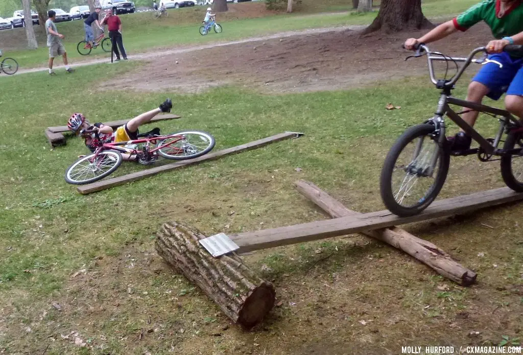 Practicing riding in a straight line, over a board and log setup © Cyclocross Magazine