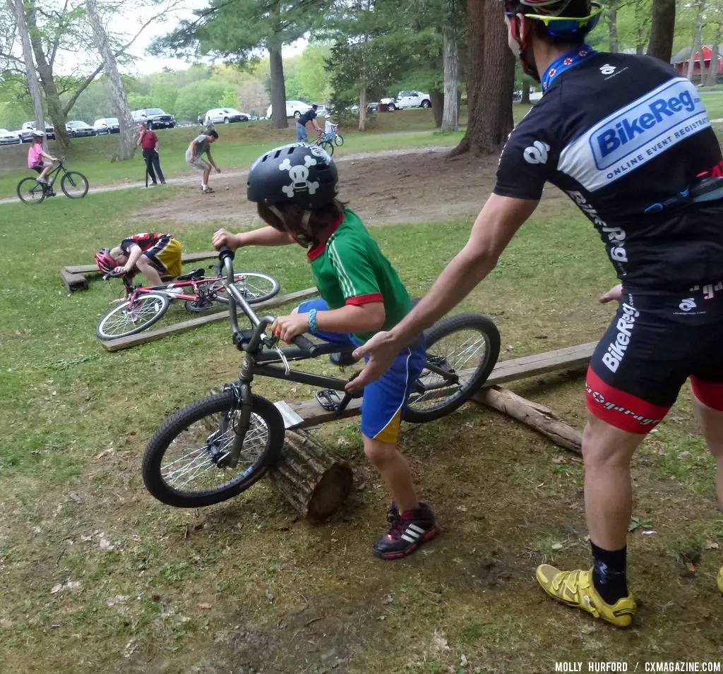 Practicing riding in a straight line, over a board and log setup © Cyclocross Magazine