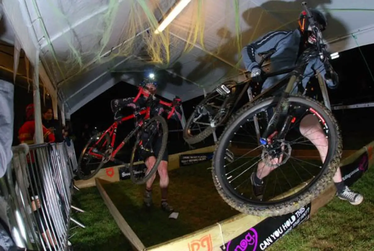 Riders tackle the barriers through the beer tent