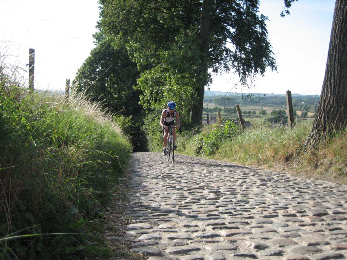 Jonas climbing the Koppenberg. The descent is on his left in the grass. by Christine Vardaros