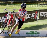 Zach McDonald clears the barriers surrounded by his Focus sponsor logos © Mark Colton