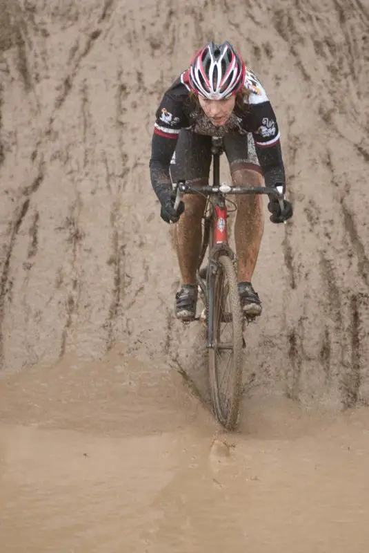 Another racer dives into the mud puddle at Raceway CX. © Karen Johanson