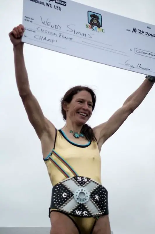 Simms on the podium sporting her trophy © Matthew J. Clark/www.strfilms.com 