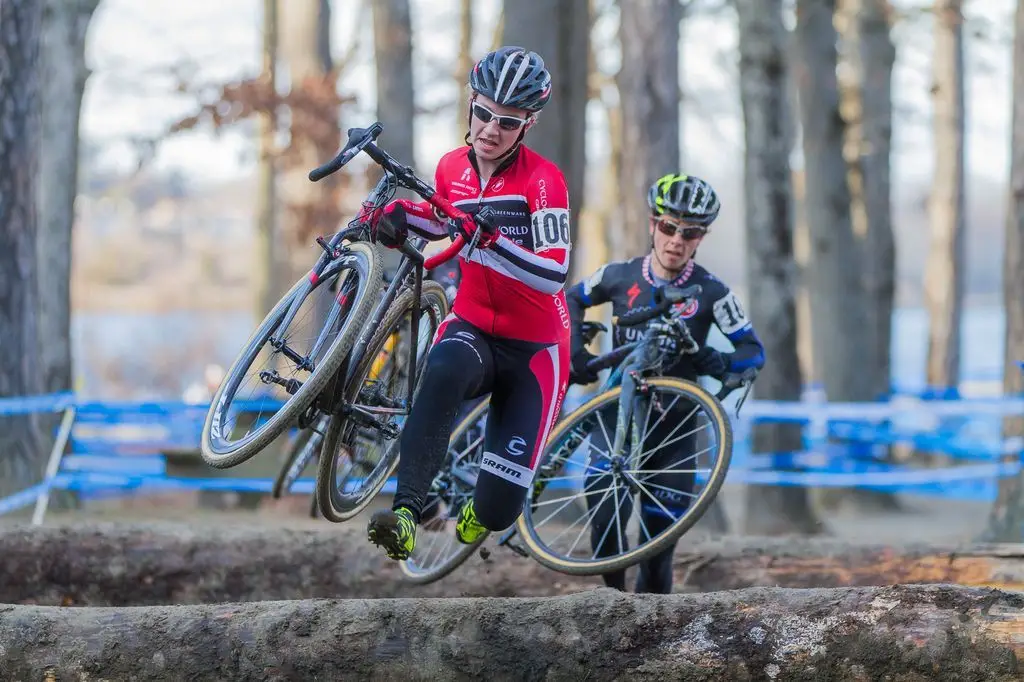 Emma White (Cyclocrossworld.com) bounding over the logs ahead of Arley Kemmerer (C3 Twenty20 Cycling). © Todd Prekaski