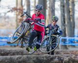 Emma White (Cyclocrossworld.com) bounding over the logs ahead of Arley Kemmerer (C3 Twenty20 Cycling). © Todd Prekaski