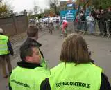 The doping control chaperones waiting for their riders to return to the finish line after their mass sprint. ? Christine Vardaros