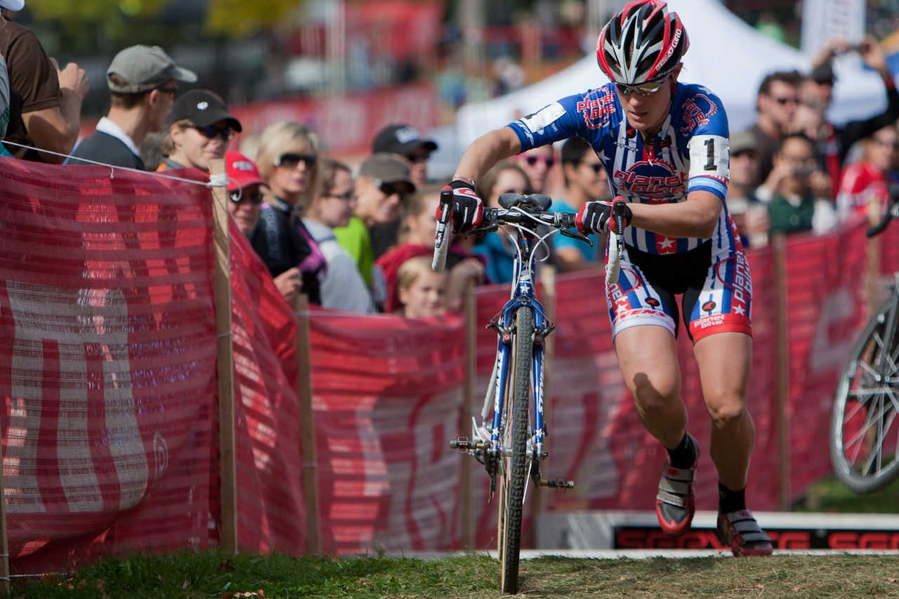 Katie Compton (Planet Bike) pulls away from the field in second lap action over the SRAM Service Course barrier section. By the third lap she was solidly away on her own. © Wil Matthews