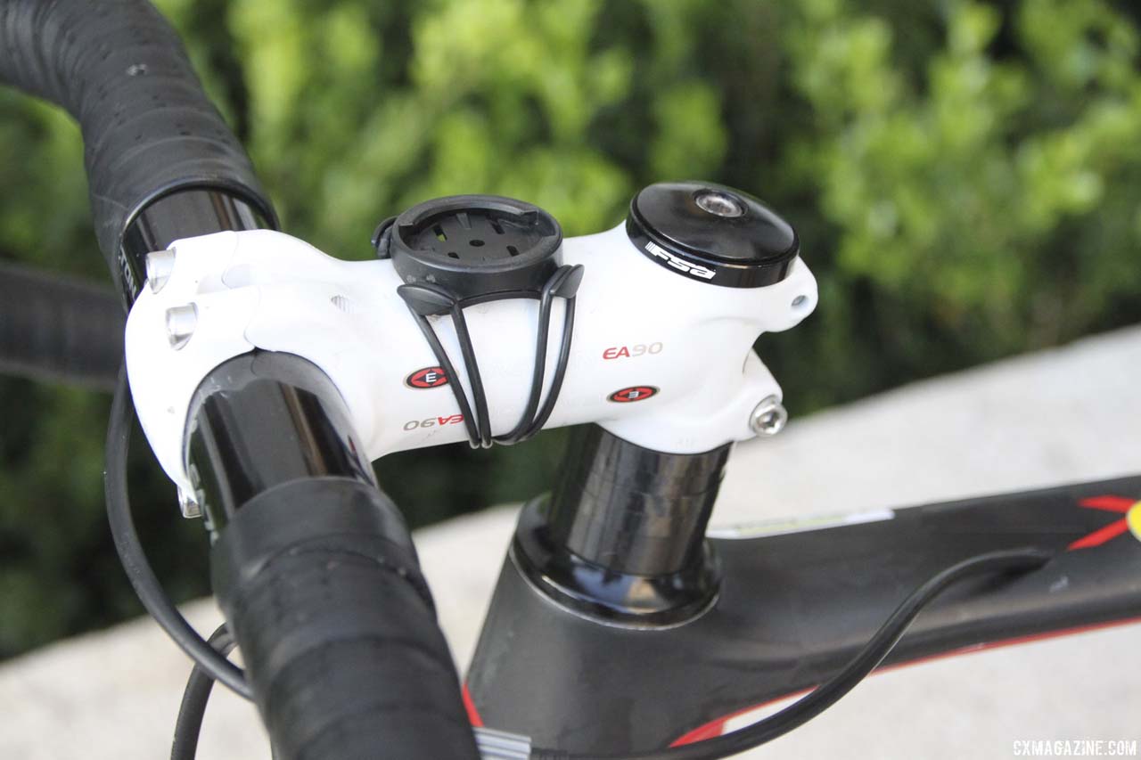Jacobs’ white Easton EA90 stem stands out against the black bike, and has a standard Garmin mount atop. The stem holds Easton’s EA70 bar as well. Note the rear derailleur cable, with in-line barrel adjuster, running through the top tube. © Cyclocross Magazine