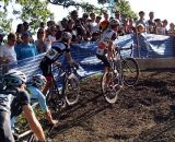 The men's pack dismounts ahead of the barriers. © Cyclocross Magazine
